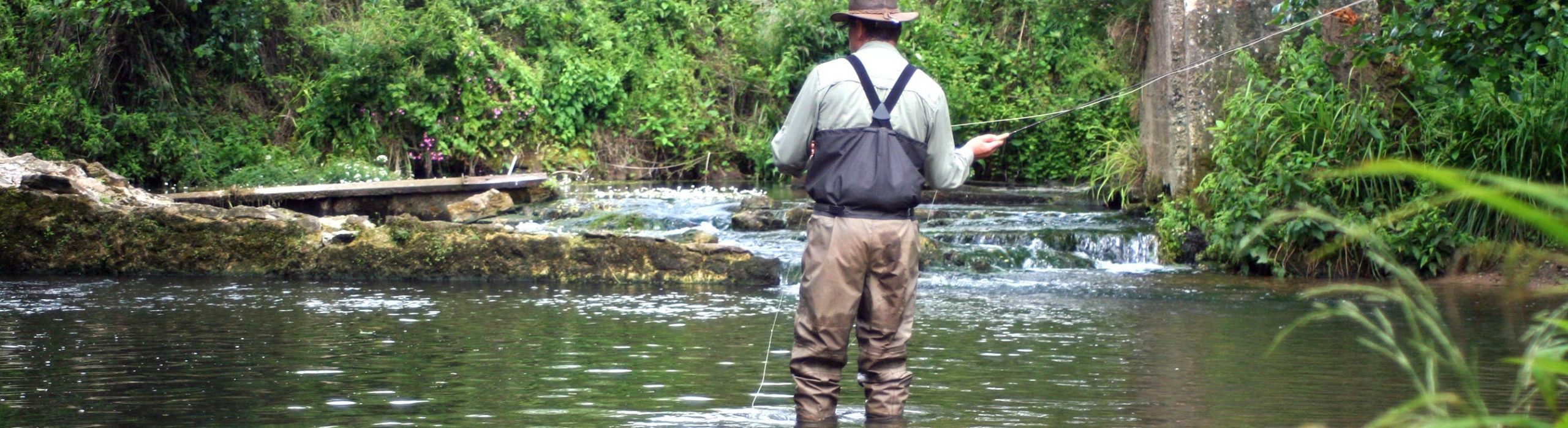 Angler on the trout stream at Folds Farm